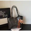 Retro charcoal grey tote bag with matte texture, gold logo, and playful monster charm - With Pendant / Black