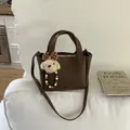 Brown lychee pattern bucket bag with bear charm and adjustable shoulder strap - With Pendant / Brown