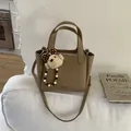 Brown lychee leather bucket bag with top handles, crossbody strap and cute bear charm - With Pendant / Khaki