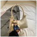 Creamy white crescent underarm bag with cute teddy bear charm and top handle strap - White With Pendant