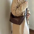Bolso medialuna minimalista en cuero marrón oscuro con correa ancha y suave - café