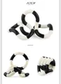Macro view of black and white twistable fidget sensory toy in multiple coiled positions - Wacky Rope Black White
