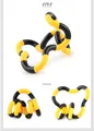 Detailed close-up of flexible yellow and black fidget toy segments in various twisted shapes - Wacky Rope Yellow Black