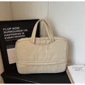 Minimalist beige quilted laptop bag with top handles for daily office and commute wear - Off White
