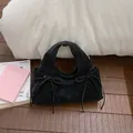 Fashionable black suede cloud handbag with bow knot ribbons and silver rings - Black