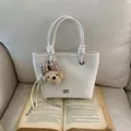 Cream white faux leather tote bag with knot handles and cute teddy bear charm - White