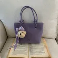 Purple minimalist leather tote bag with a cute bear charm and metal logo detail - Purple