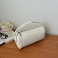 Minimalist cream white lychee pattern cylinder handbag on a wooden table with lifestyle props - Off White