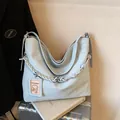 Large light blue hobo bag with a chunky braided strap and detachable card holder pouch - Blue