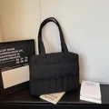 Black quilted puffer tote bag with front pocket for daily commute and laptop storage - Black