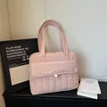 Pink quilted tote bag with padded nylon material and long handles for daily commute - Pink