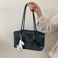 Modern charcoal tote bag with slim straps and a decorative leather horse charm detail - Black