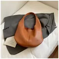 Minimalist brown pebbled leather underarm shoulder bag with slouchy crescent design - Brown