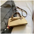 Detail view of beige fabric and brown leather handbag with gold metal feet on blazer - No Pendant / Khaki
