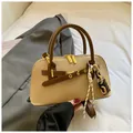 Detail of khaki square crossbody bag with gold hardware and two-tone chain charm - With Pendant / Khaki