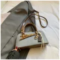 Detail of square canvas crossbody bag with brown leather straps and chocolate pendant - With Pendant / Blue