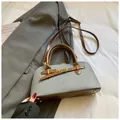 Detail of grey fabric and brown leather crossbody bag with golden protective rivets - No Pendant / Blue