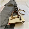 Detail of canvas and brown leather handbag with creative chocolate charm and metal feet - With Pendant / Off White