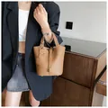 Brown litchi grain leather bucket bag with gold lock and smiley face charm - Brown