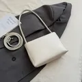 Minimalist soft leather crossbody bucket bag in cream white with slim shoulder strap - White