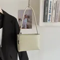 Minimalist sage green bucket bag in soft faux leather with silver chain charm - Green with Pendant