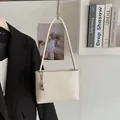 Creamy beige minimalist bucket bag with long shoulder strap and silver crescent charm - White With Pendant
