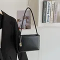 Minimalist black faux leather bucket bag with silver chain detail and thin strap - Black With Rabbit Pendant