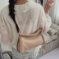 Bolso de hombro en cuero beige con patrón de lichi, anillos dorados y estilo minimal - Caqui