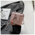 Detail of a pink quilted mini vanity box bag with silver flower logo and chain strap - S / Pink