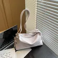 Chic light purple glossy leather pillow bag with adjustable strap in minimalist style - Purple