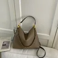 Brown lychee grain leather tote bag with gold chain strap and spacious interior - Elephant Gray