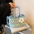 Light blue hand-woven bucket bag with tulip patterns and a long crossbody strap - Blue Large