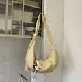 Minimalist beige crescent hobo bag with knotted strap and small horse charm - With Pendant / Yellow