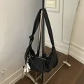 Black pebbled leather croissant hobo bag with knotted wide strap and horse charm - With Pendant / Black