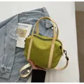 Minimalist avocado green canvas handbag with cream handles and adjustable shoulder strap - L Green
