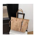 Large tote bag with brown geometric print and decorative charm on a white suitcase - Khaki