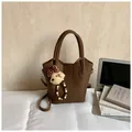 Dark brown lychee pattern handbag with bear charm and adjustable shoulder strap - Brown with Pendant