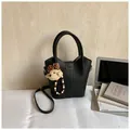 Minimalist black lychee pattern leather bucket bag with a cute bear plush charm - Black With Rabbit Pendant