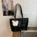 Glossy black large tote bag with shoulder straps and white plush doll charm - Black