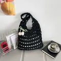 Handmade black hollow woven tote bag with tulip pendant and green bow detail - Black