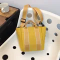 Vibrant yellow canvas bucket bag with adjustable wide shoulder strap for daily fashion - Yellow