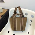 Brown canvas bucket bag with wide detachable strap and white stitching detail - Brown