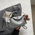 Light gray dumpling handbag with a silver turn-lock and cute teddy bear charm - Blue with Pendant