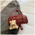 Dark red patent faux leather crossbody pillow bag with plush bear charm and handles - Red with Pendant