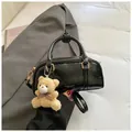 Black wrinkled patent leather Boston bag with gold hardware and a cute teddy bear charm - Black With Rabbit Pendant