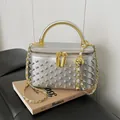 Silver rivet vanity case bag with gold hard handle and chain strap on a book base - Silver