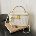 Elegant white box bag with pearl embellishments, gold handle, and chain strap - Off White