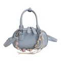 Minimalist light blue oval shoulder bag with silver hardware and beaded charm detail - Blue