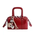 Minimalist red leather Boston bag with plush heart charm and silver hardware accents - With Pendant Style / Red