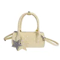 Light yellow polka dot bowling handbag with star charms and adjustable strap - Yellow